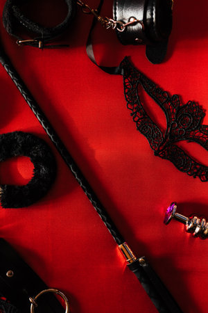Set of toys for adults: handcuffs, anal plug, mask, whip. The view from the topの写真素材