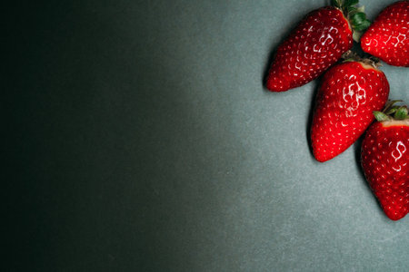 ripe strawberry berries on a dark background. space for your text