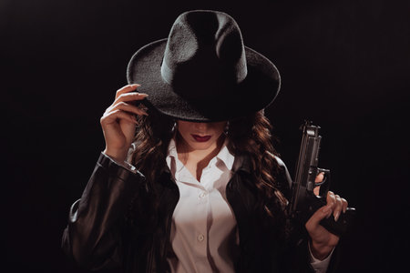 Silhouette of a female detective in a coat and hat with a gun in her hands. A book drama noir...
