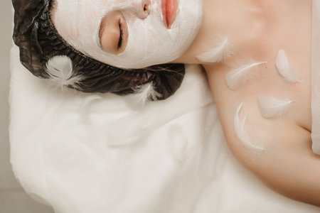 Top view of the client relaxing in the cosmetologists office with a mask on her faceの写真素材