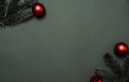 Christmas tree branches, and balloons on a solid green background. Empty space for your ad or text.の写真素材