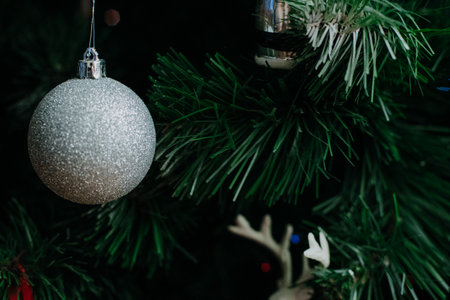 Christmas tree decorated with a garland and Christmas toys. Close up.の写真素材