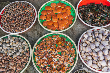 A variety of Fresh edible oysters, clams and scallops at the local market in Nha Trang, Vietnam.