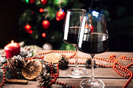 Glasses of wine on the background of a decorated Christmas tree. New year moodの写真素材