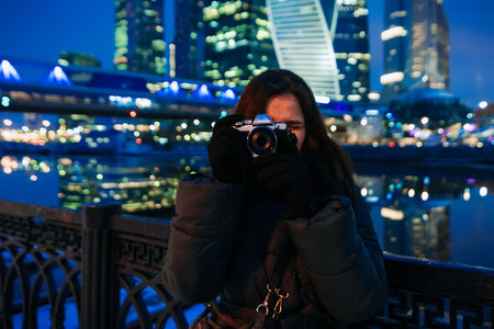 beautiful young girl stands on the background of Moscow city in winterの写真素材