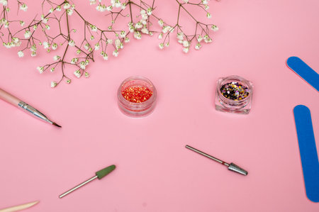 Manicure and pedicure tools on a pink background. Nail salon banner design template. The concept of cosmetic procedures and hand careの写真素材