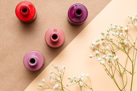Nail polish of different colors in glass tubes stands on a light background.の写真素材