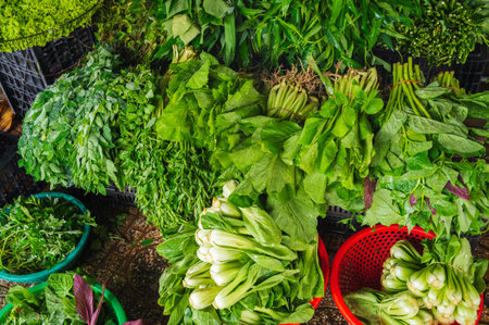 Various vegetables and herbs on the market in baskets.の写真素材