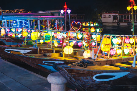 Boats decorated with burning lanterns on the river at night, Hoi Anの写真素材
