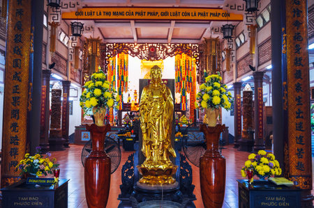 Golden Buddha in the interior and altar of a Buddhist temple in Asia, Vietnam.の写真素材