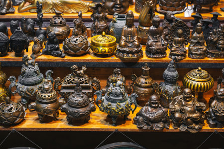 There are many metal Buddha statues in the local Asian marketの写真素材