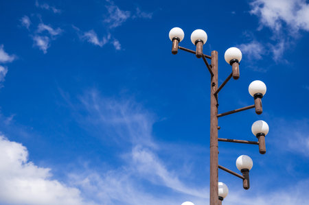 An elegant street lamp post rises above the clear blue skyの写真素材