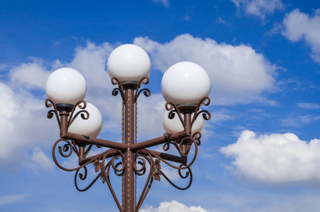 An elegant vintage street lamp beautifully stands out against the clear, blue sky aboveの写真素材