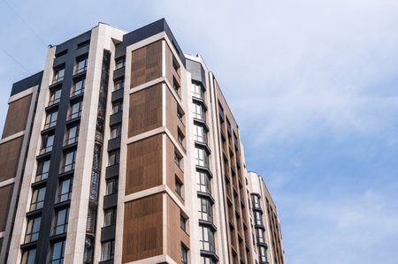 The facade of a new apartment building against the sky .の写真素材