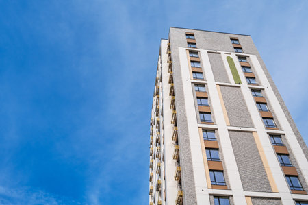 Beautiful modern high-rise residential building against the skyの写真素材