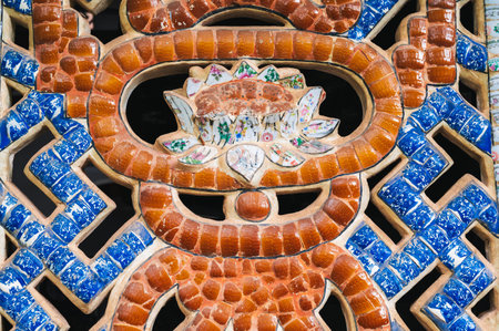 a pattern and a lotus flower made of small ceramic tilesの写真素材
