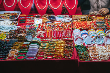 A showcase with jewelry made of gold, silver and jade for sale on the marketの写真素材