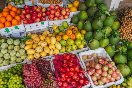 A counter with tropical fruits at an Asian local market in Vietnam.