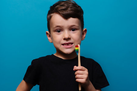 A boy with no front teeth. With a toothbrush in hand. Dental hygiene.の写真素材