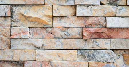 Panorama of outdoor wall tiles, natural stone wall background, facade tiles.