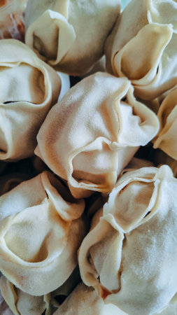 Russian handmade dumplings, production. The raw dumplings were placed on a wooden cooking board.の写真素材
