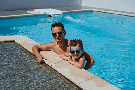 Little boy with father in swimming poolの写真素材