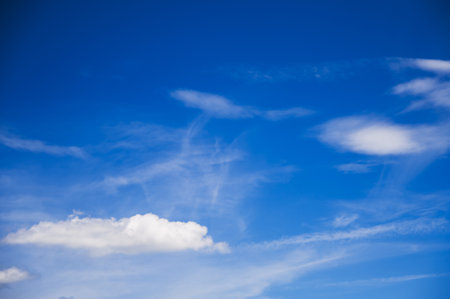 Snow-white clouds on a blue sky on a sunny summer dayの写真素材