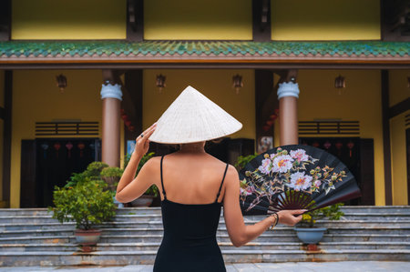 A tourist woman in a Non La hat on the background of beautiful landscapes at the Linh Ung Son Tra pagoda in Da Nang.の写真素材