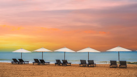 Panoramic Scenic view of the sandy beach with umbrellas and sun beds on the coastline.の写真素材