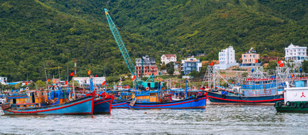 panoramic view of Traditional Vietnamese fishing boats, ships and vessels at the fishing seaport on the seashore in Nha Trang, Vietnam.の写真素材