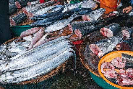 Fresh fish in baskets, freshly caught at sea, is sold at a fish market in Asia.