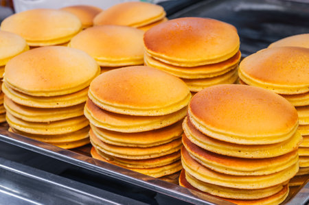 A stack of pancakes in close-up on a dark dish.の写真素材