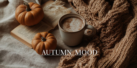 lettering AUTUMN MOOD on a pumpkin background, scarf, book and warm drink in flatlay, cozy autumn tones.の素材