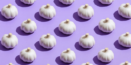Garlic bulbs on a colored background, colorful garlic pattern. Panoramic banner.の素材