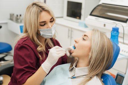 Dentist examining a patients teeth in the dentist.