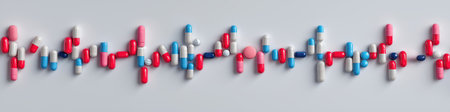 flatlay of pills and capsules forming ECG heartbeat line on white background, medical concept. Panoramaの素材