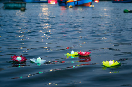 Floating lotus-shaped flashlight at a Buddhist festivalの写真素材