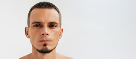 Portrait of a man using under-eye cosmetic patchesの写真素材