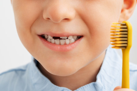 close-up of childs teeth with missing baby tooth and toothbrushの写真素材