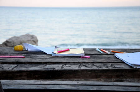 Wooden table by the sea for drawingの写真素材