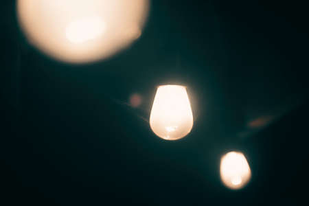 A string of lights hanging in the dark.の写真素材