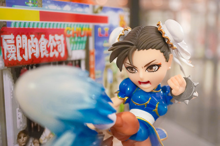 BANGKOK - MAY 7, 2016 : Portrait of Chun-Li mascot to promote the game in Thailand Toy Expo 2016. She is a character from Street Fighter Game, abstract pixel backgroundのeditorial素材