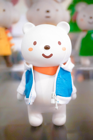BANGKOK - MAY 7, 2016 : Portrait shot of "Ordinary Bear" vinyl mascot wearing orange scarf and his casual blue jacket along with other friends on the background. Character designed by Fluffy House.のeditorial素材