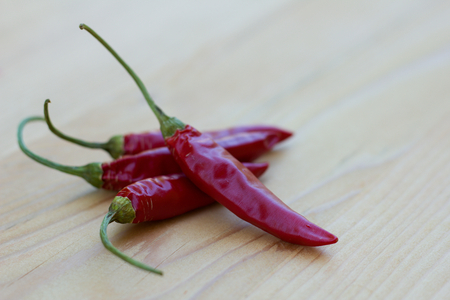 Chili peppers on wooden tableの写真素材