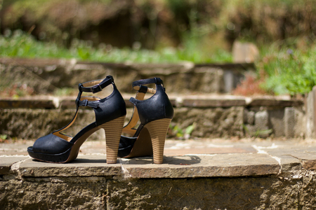 Women's shoes on the stairs in sunlightの写真素材