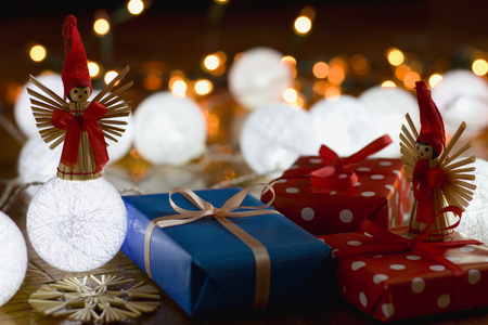 Christmas gifts and decorations with christmas lights as background, gift boxes with ribbonの写真素材