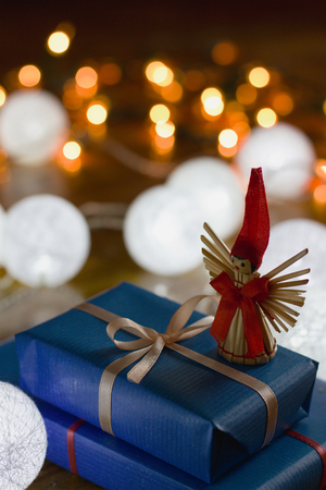 Christmas gifts and decorations with christmas lights as background, gift boxes with ribbonの写真素材