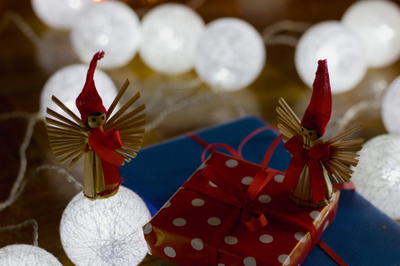 Christmas gifts and decorations with christmas lights as background, gift boxes with ribbonの写真素材