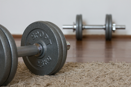 Dumbbells on the wooden floor, equipment for fitnessの写真素材