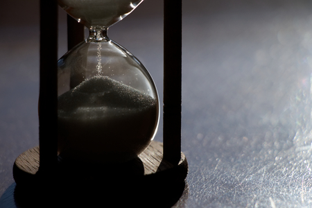 Hourglass time passing in contrast backlit. sandglass in sunlightの写真素材